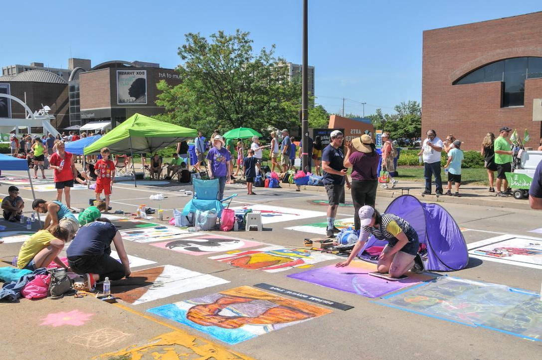 Community members draw with chalk on the streets of Fort Wayne.