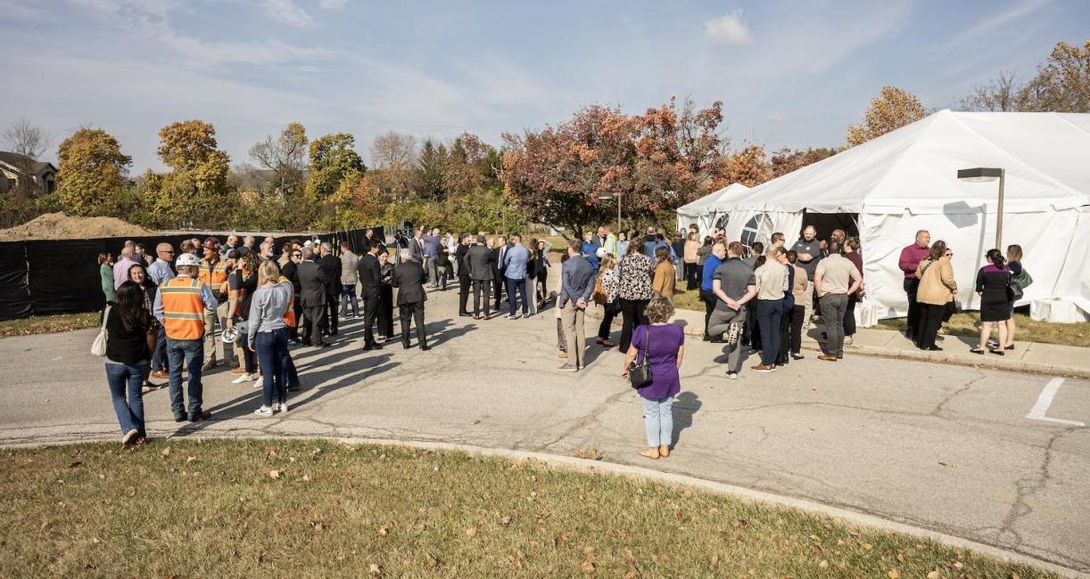 Trace groundbreaking crowd.